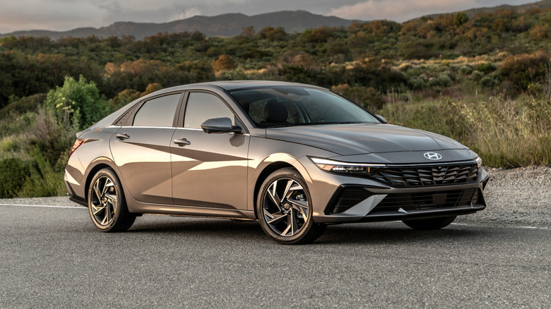 Hyundai Elantra parked roadside with hills in the background