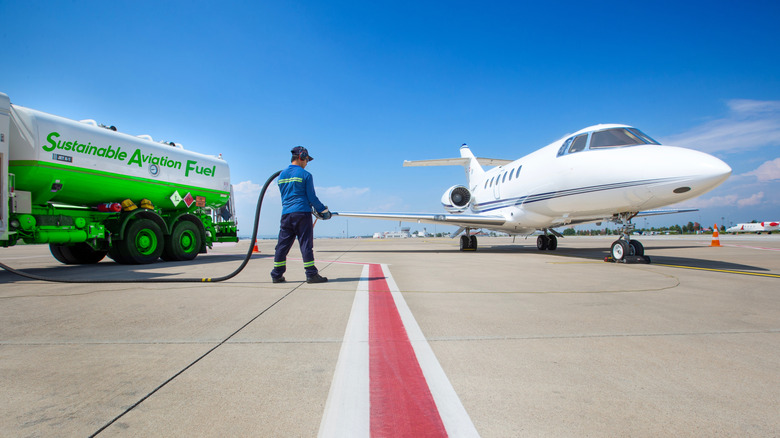 A technician refuelling a private jet aircraft