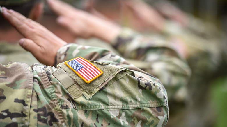 Military service members saluting