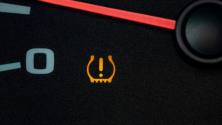 Tire pressure light flashing under dashboard needle