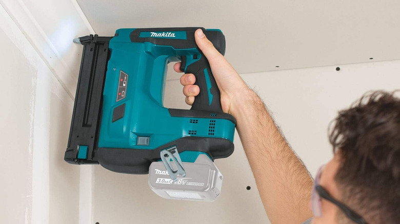 person using makita nailer