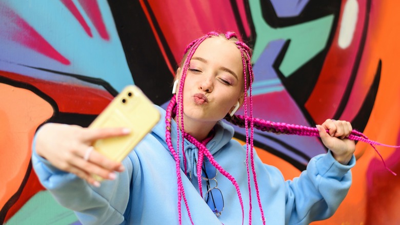 young woman taking a selfie with a smartphone