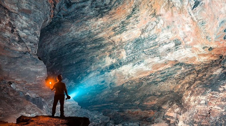 person shining Imalent MS32 Flashlight at rocks