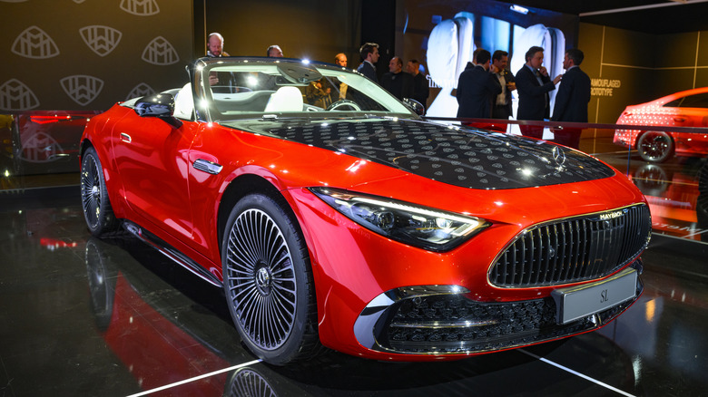 A red 2026 convertible Mercedes SL 680 parked on display.
