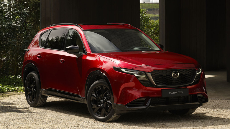 Front 3/4 view of Mazda CX-5 parked in residential setting