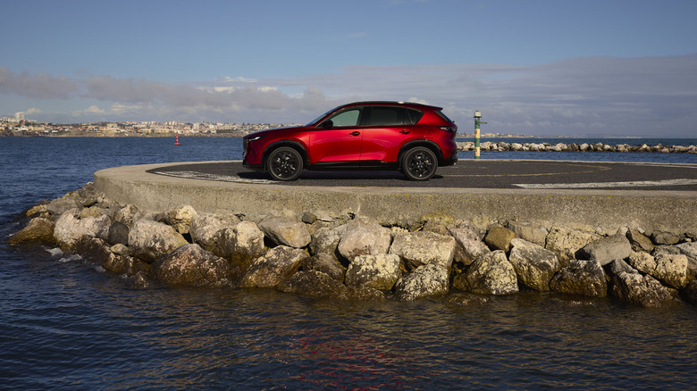 Long shot of side of Mazda CX-5 parked in seaside setting