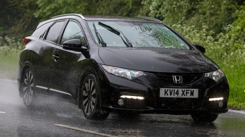 black 2014 honda civic driving in rain