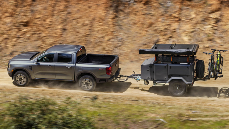 Overhead view of gray Ford Ranger pulling trailer on mountain trail.