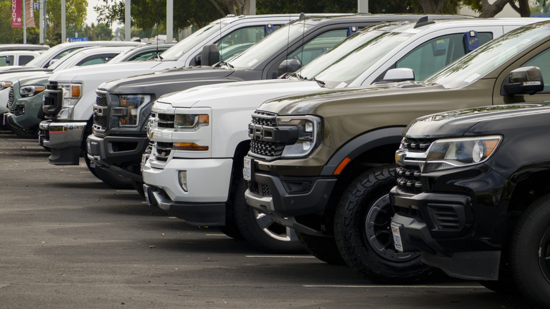 Front view of used pickup trucks lined up on CarMax lot.