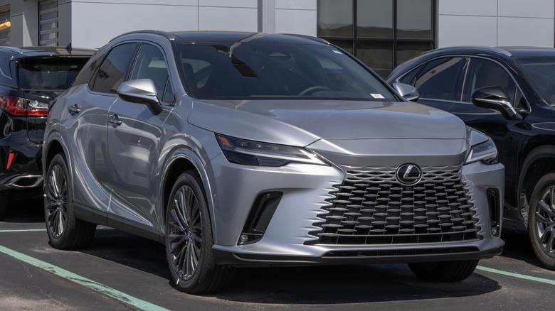 A gray Lexus RX 350 parked in front of a dealership.