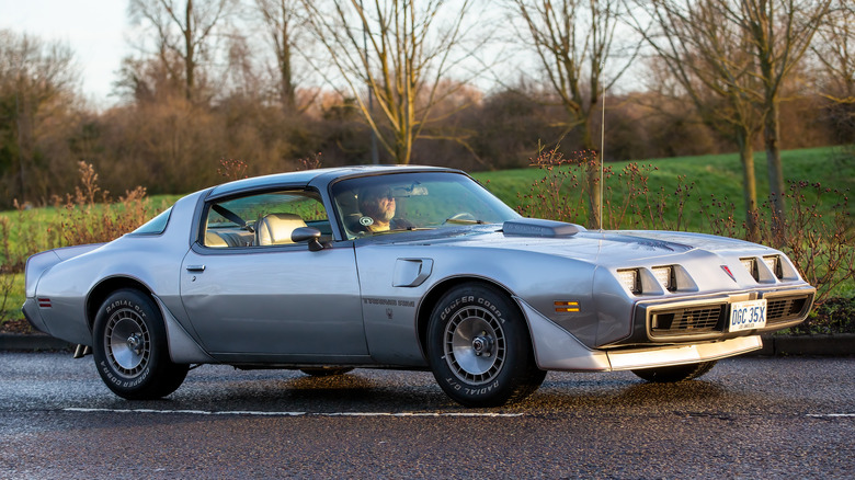 Silver Pontiac Trans Am driving