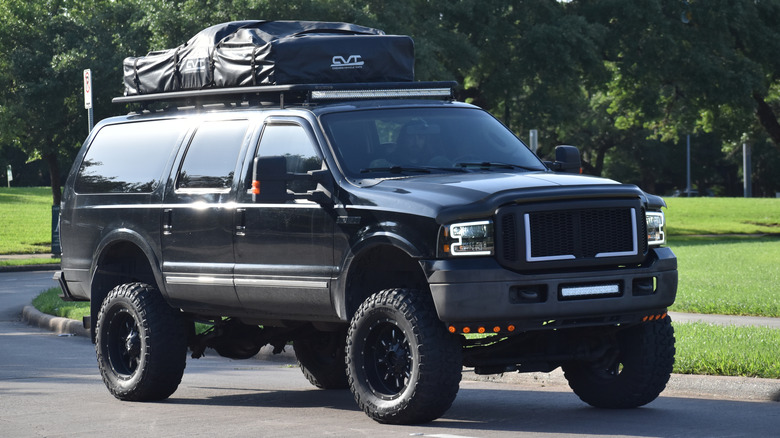 Modified Ford Excursion on road
