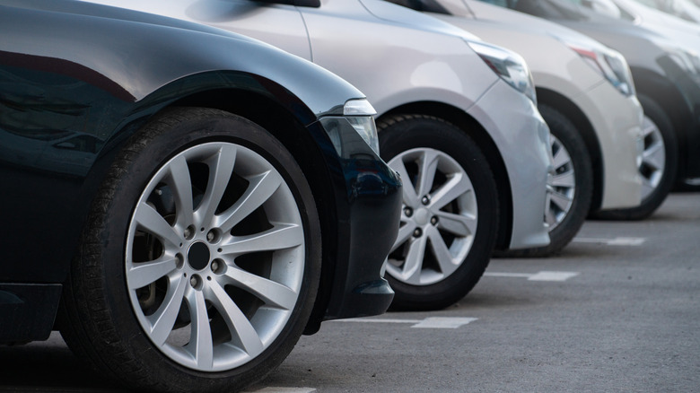 Row of sedans at car dealership