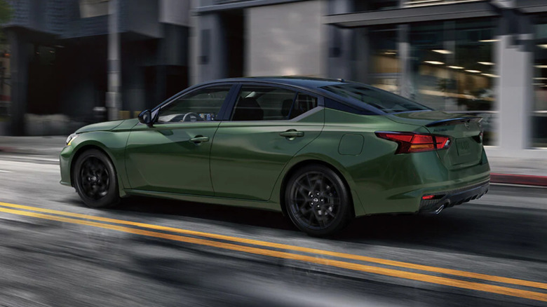 Nissan Altima driving fast down street