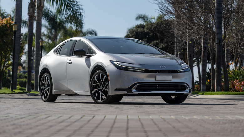 A silver 2025 Toyota Prius PHEV XSE parked on a paved surface, front 3/4 view