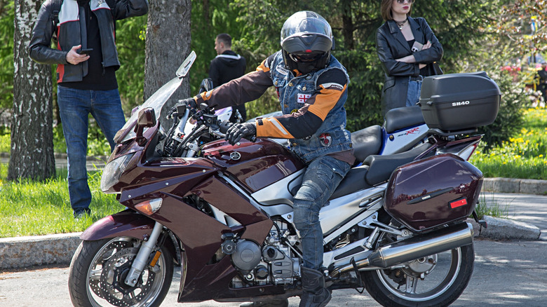 Biker on touring motorcycle Yamaha FJR1300 dark cherry color.