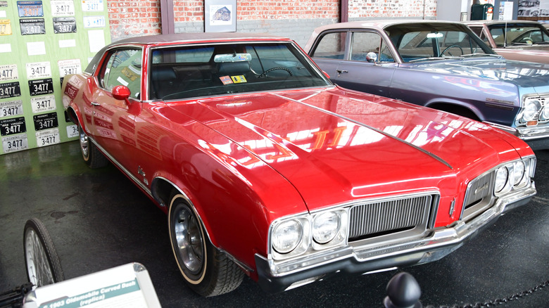 Red 1970 Oldsmobile Cutlass Supreme SX seen from front right on display at Virginia Museum of Transportation