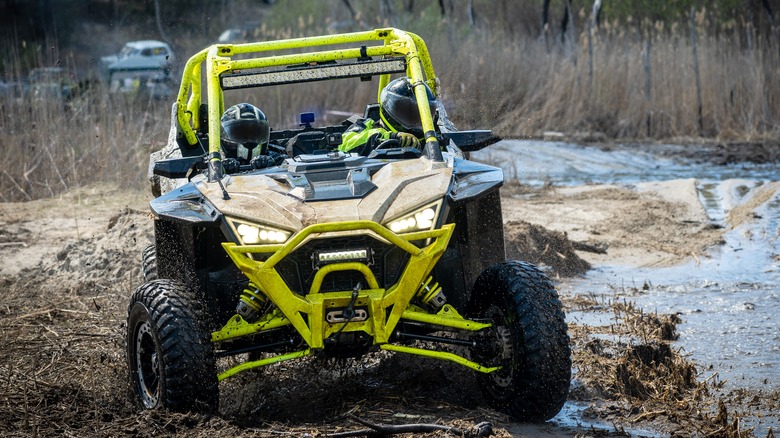 Polaris UTV driving through mud