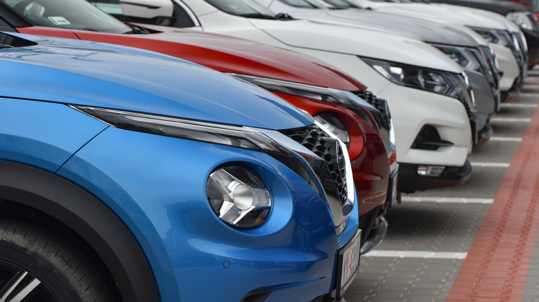 several nissan vehicles parked in row