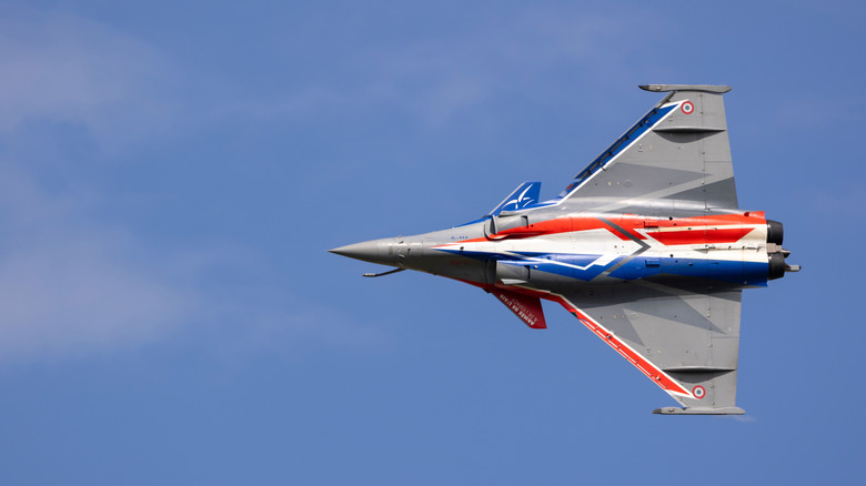 underside of french fighter jet in bank