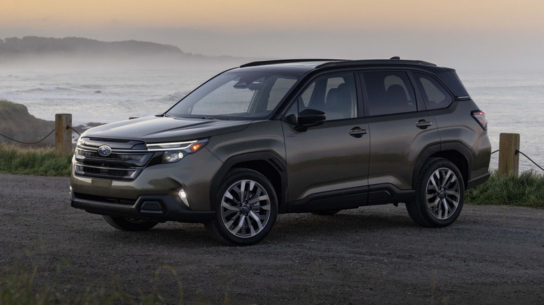 forest green 2025 Subaru Forester Hybrid parked by the seaside