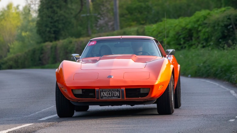 1975 Chevrolet Corvette driving on a country road