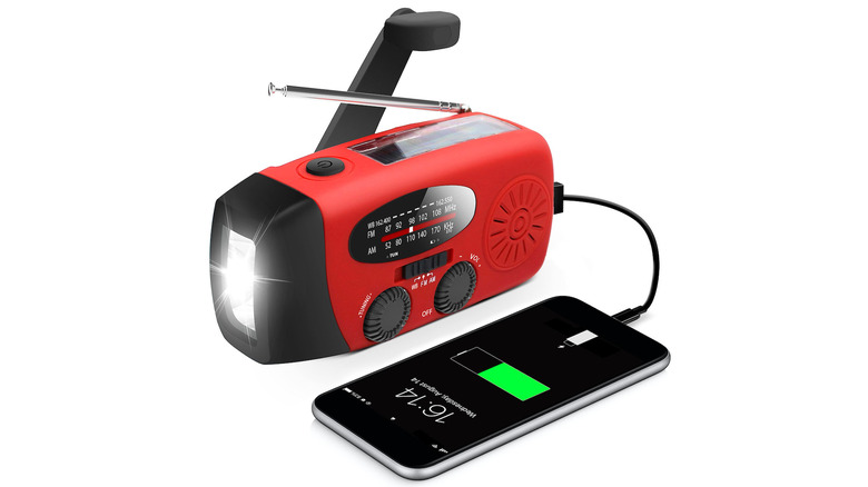 red RunningSnail Emergency Hand Crank Radio with LED Flashlight charging a phone