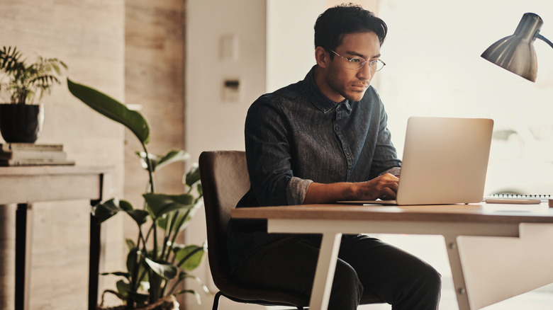 person using laptop at a desk