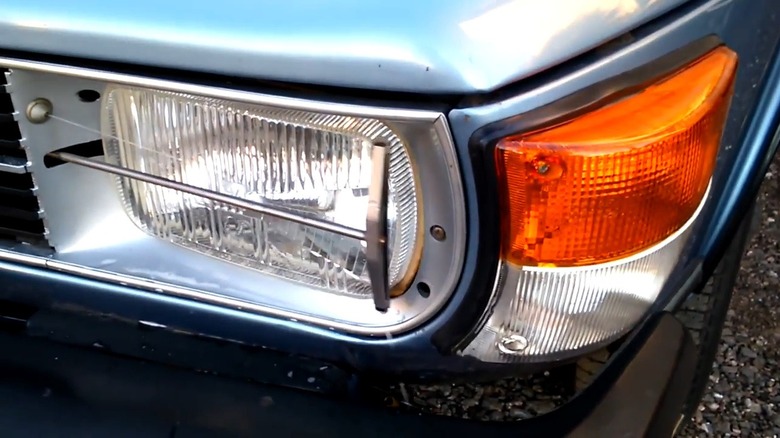The headlight wiper system in action on the Saab 99