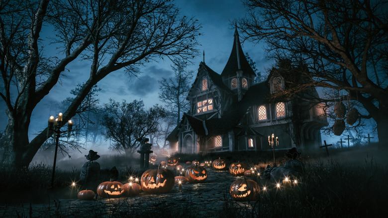 Haunted house at night with windows illuminated
