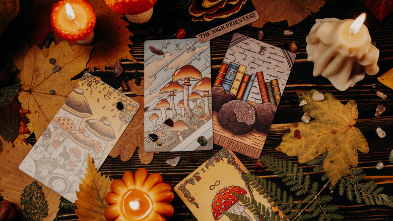 Collection of tarot cards on a fall-decorated table