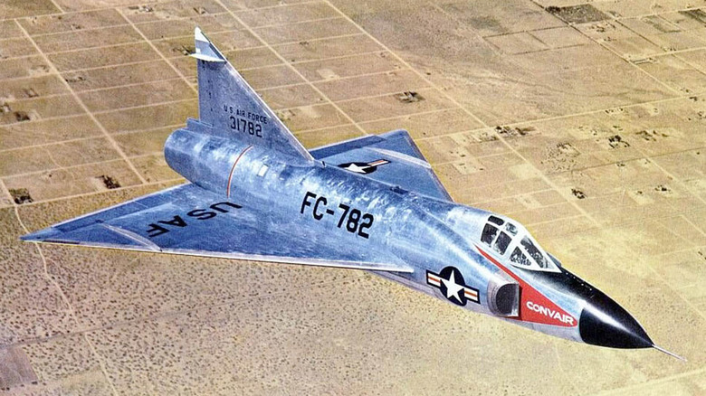 An F-102 Delta Dagger in mid-flight over an arid area