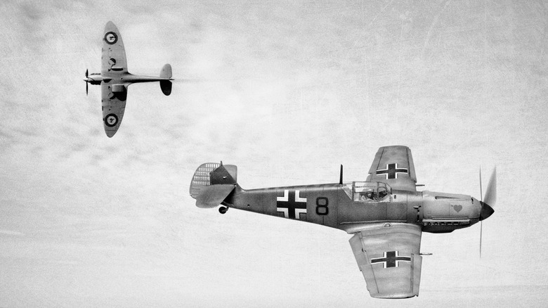 two world war II fighter planes making a pass