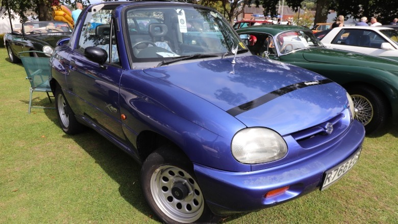 Blue Suzuki X-90 parked on grass at a car show
