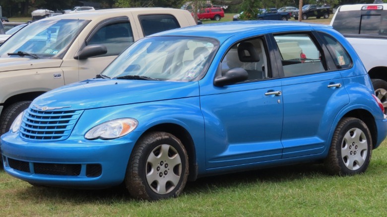 Blue Chrysler PT Cruiser parked on grass