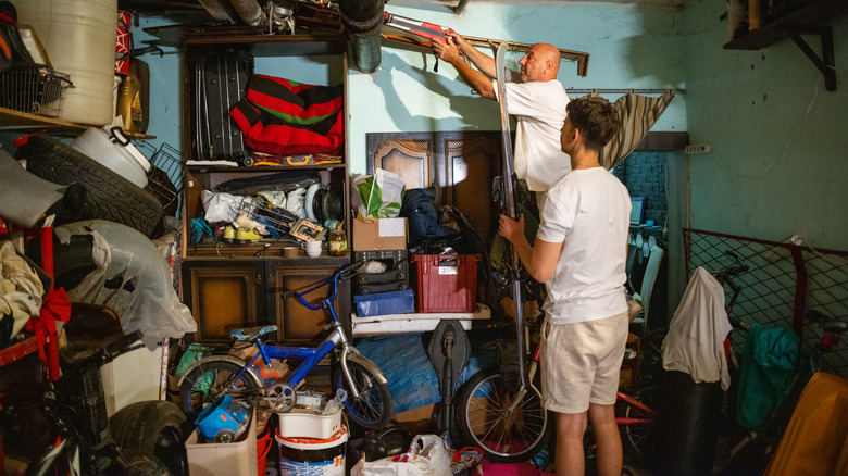 Two man inside a messy garage