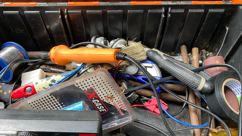 The inside of an untidy tool box