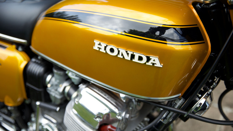 A close up of a vintage yellow Honda CB750 motorcycle