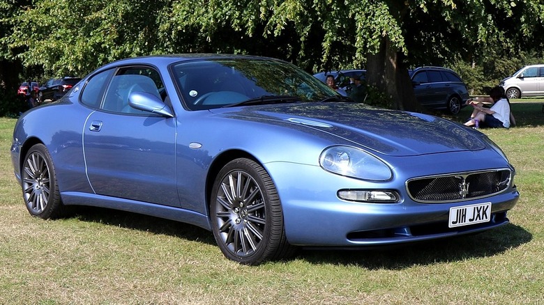 A Maserati 3200 GT parked in a green field.