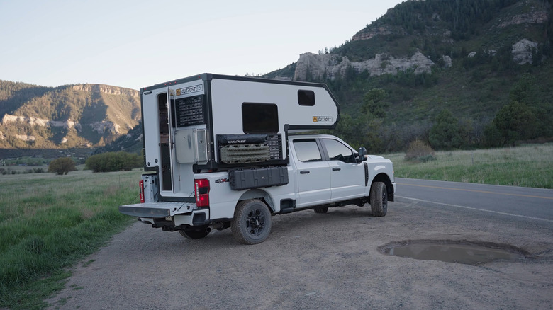 A 2025 2025 Outpost 6.5 attached to a Ford F-Series pickup truck