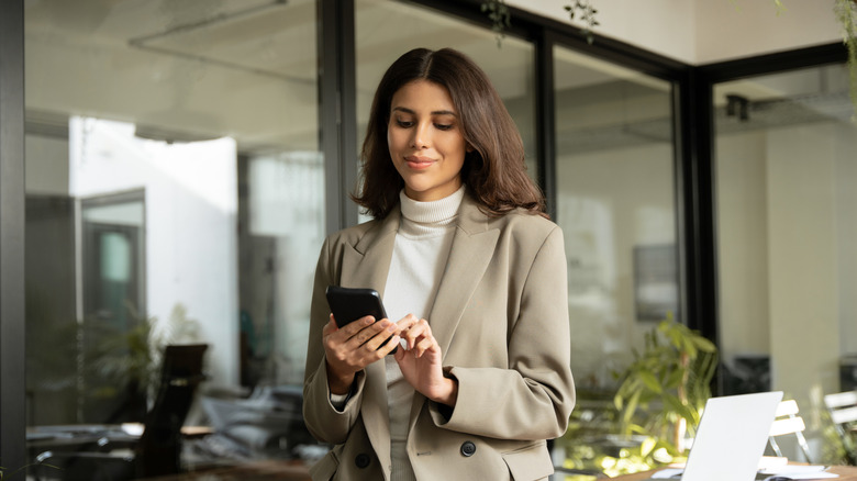 woman using iPhone in office