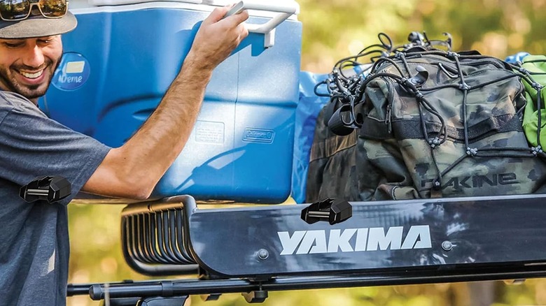 man putting cooler on cargo basket