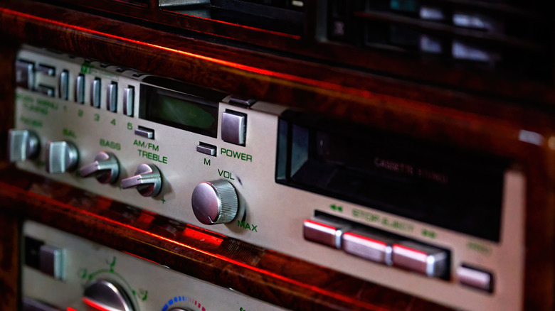 Close up view of silver-colored stereo tape deck in vintage car.