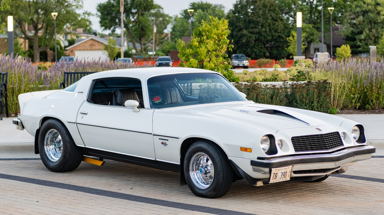 Front 3/4 view of of white modified 1970s Chevy Camaro.