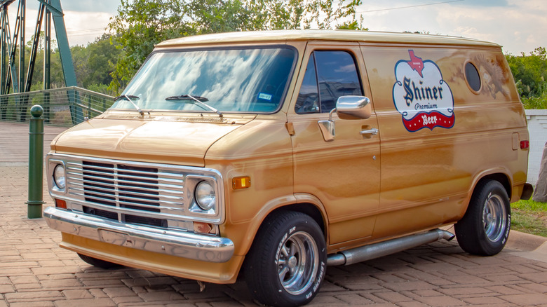 Front 3/4 view of gold-colored custom 1970s Chevy van.