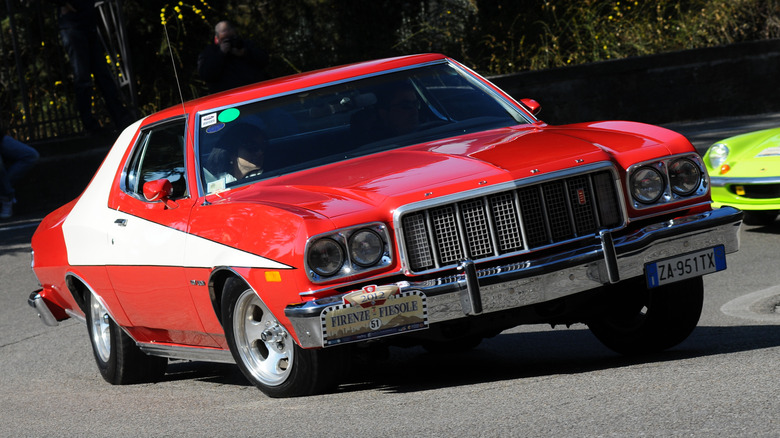 Front view of Starsky & Hutch replica Ford Torino taking a corner during classic car rally.