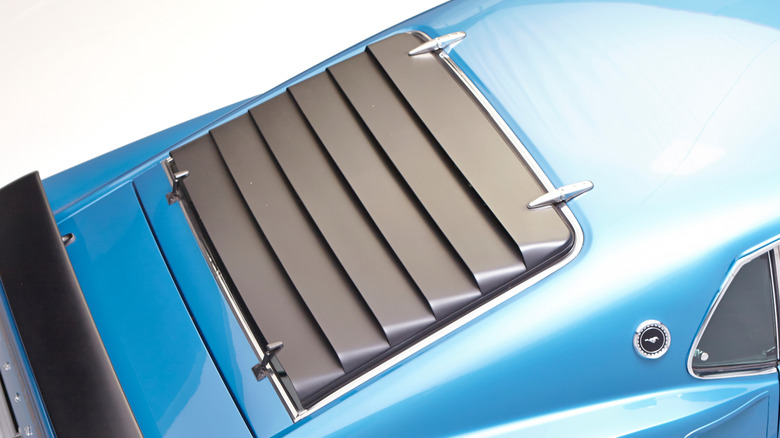 Overhead view of rear window louvers on blue Ford Mustang fastback.