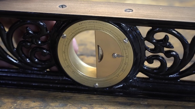 An antique Davis level on a table.