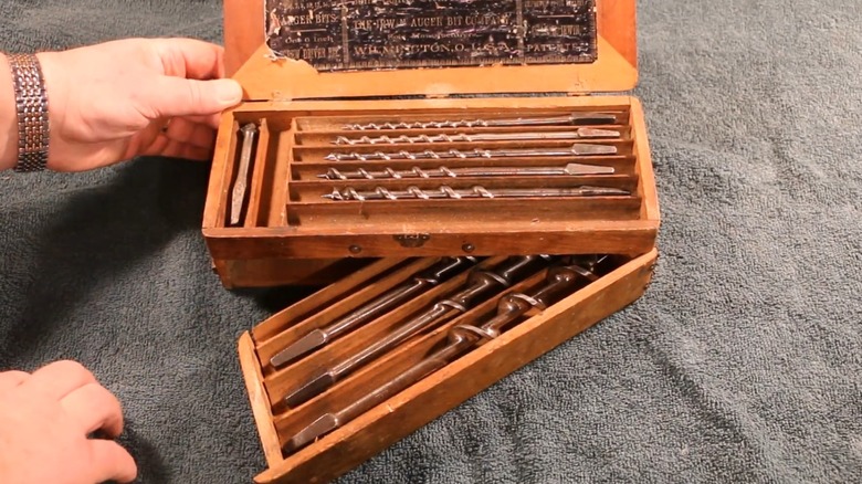 A person opening a Russell Jennings auger bit set.