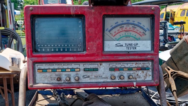 A vintage Sun Tune-Up tester in a landfill.